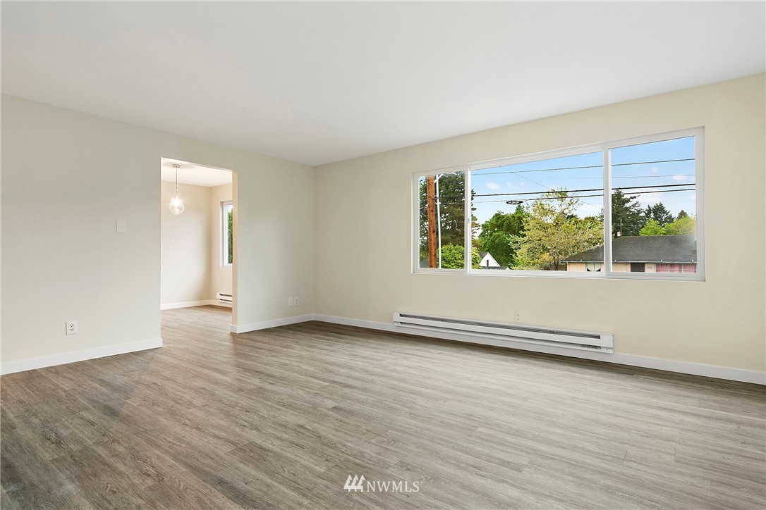 742 North 92nd Street Seattle, WA 98103 - Photo 8 of 16 an empty room with wooden floor and windows