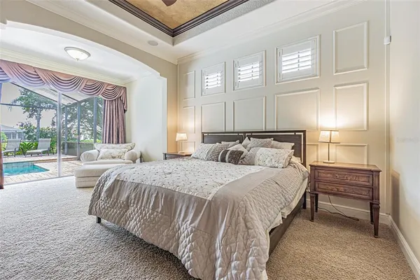 a bedroom with a bed and a large window