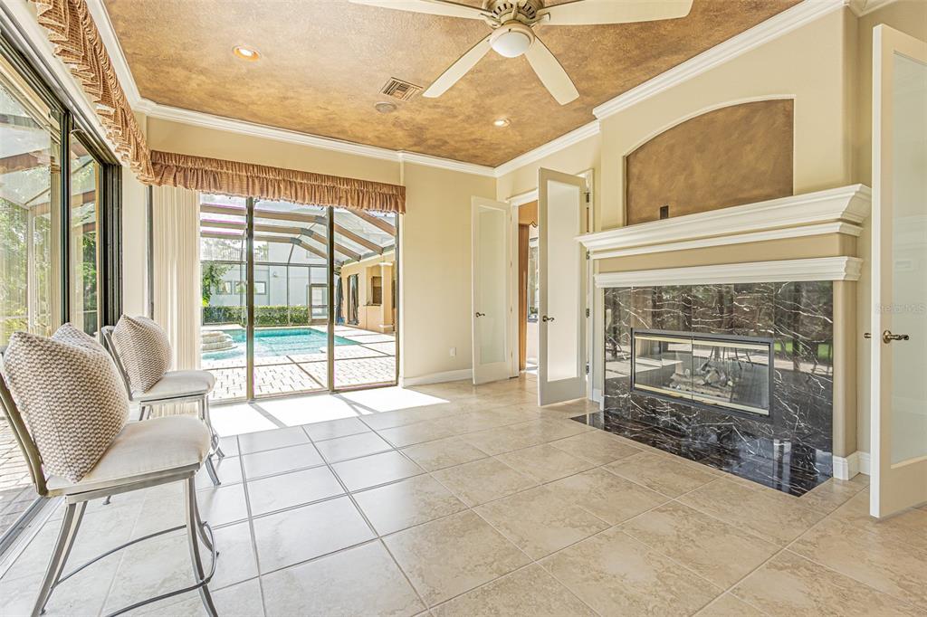 20411 Lace Cascade Road Land O Lakes, FL 34637 - Photo 16 of 44 a view of a livingroom with a fireplace and a ceiling fan