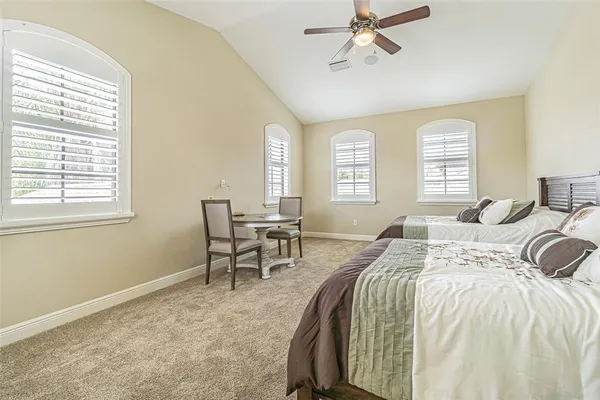 a spacious bedroom with a bed and a table