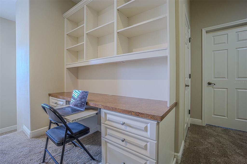 20411 Lace Cascade Road Land O Lakes, FL 34637 - Photo 32 of 44 a room that has a table and chair in it