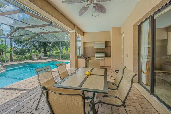 a view of an outdoor dining space with a table and chairs