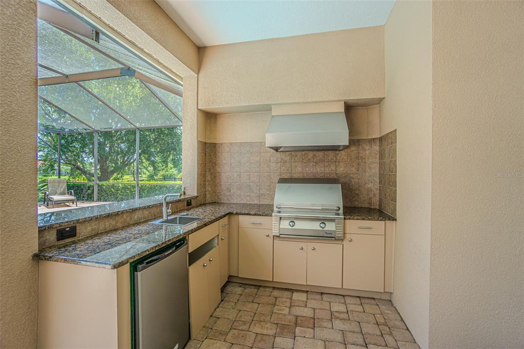20411 Lace Cascade Road Land O Lakes, FL 34637 - Photo 35 of 44 a kitchen with a sink stove and cabinets