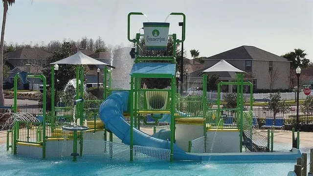 a large kitchen with stainless steel appliances a large counter top a sink a stove and wooden floors