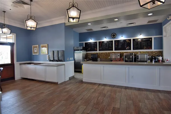 a dining room with furniture and wooden floor