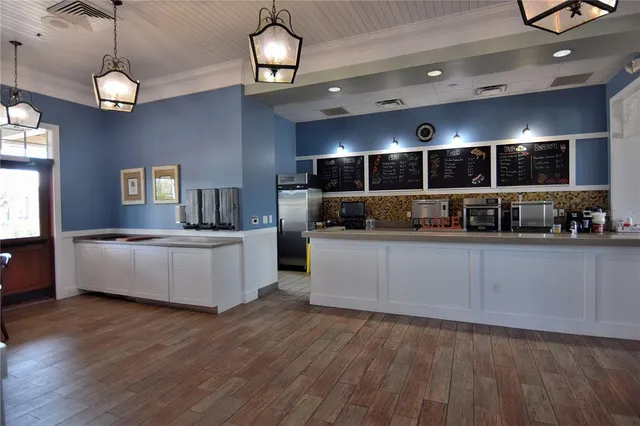 a dining room with furniture and wooden floor