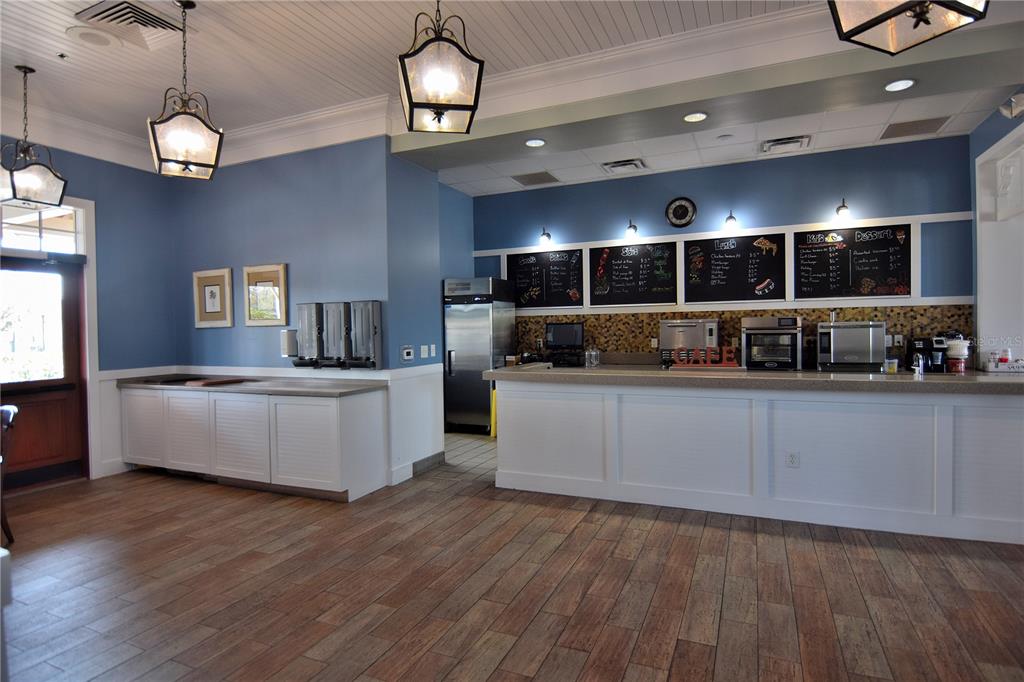 20411 Lace Cascade Road Land O Lakes, FL 34637 - Photo 39 of 44 a large kitchen with stainless steel appliances a large counter top a sink a stove and wooden floors