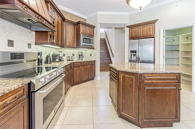 a kitchen with stainless steel appliances granite countertop a stove and a sink