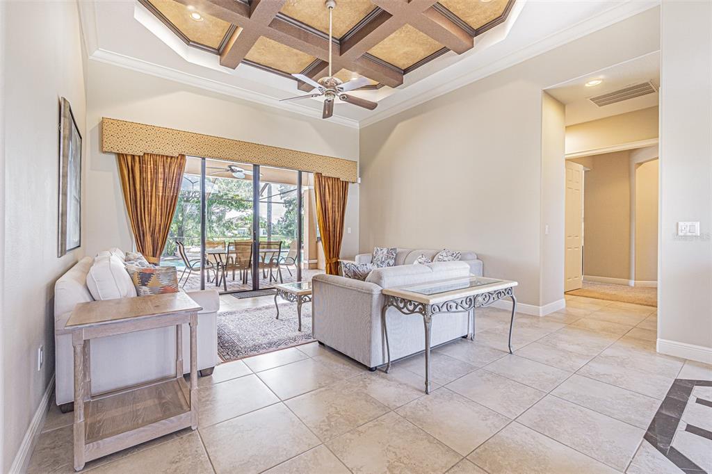 20411 Lace Cascade Road Land O Lakes, FL 34637 - Photo 7 of 44 a living room with a large window and a table