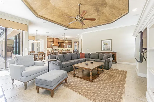 a living room with furniture and a chandelier