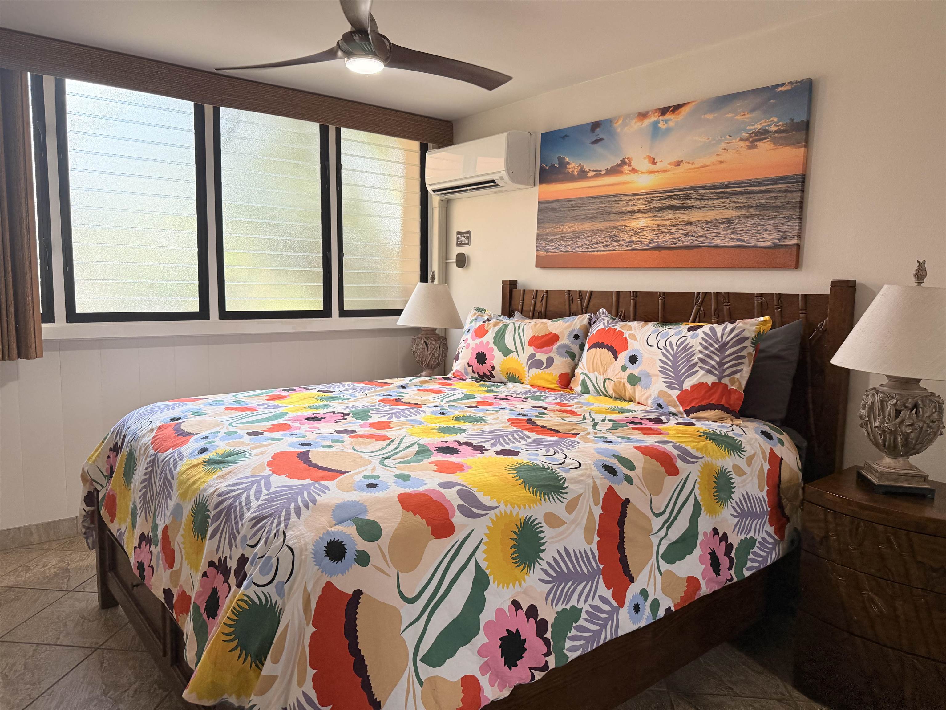 3701 Lower Honoapiilani Road, Unit 105 Lahaina, HI 96761 - Photo 12 of 36 a bedroom with a bed and a painting on the wall