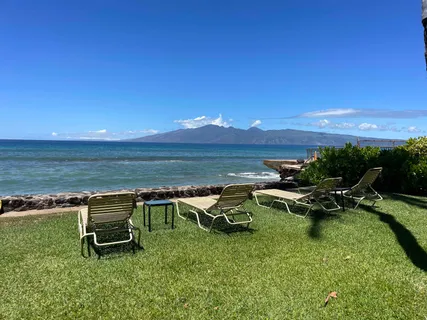 a view of a swimming pool with lawn chairs