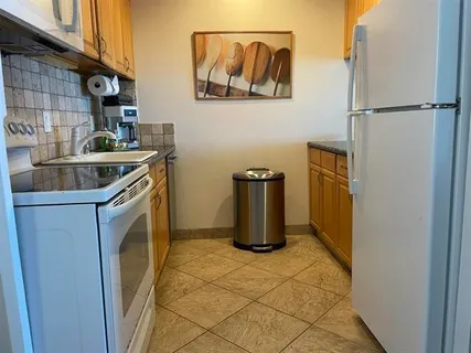 a kitchen with a refrigerator and a sink
