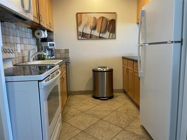 3701 Lower Honoapiilani Road, Unit 105 Lahaina, HI 96761 - Photo 7 of 36 a kitchen with a refrigerator and a sink