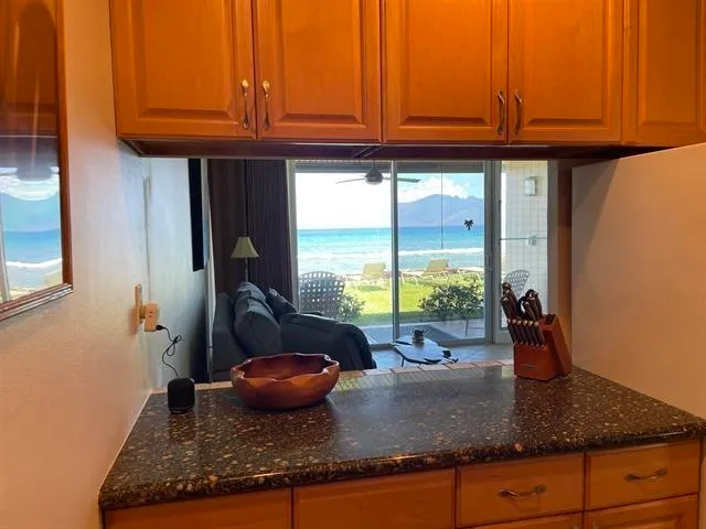 a kitchen with granite countertop a sink and a window