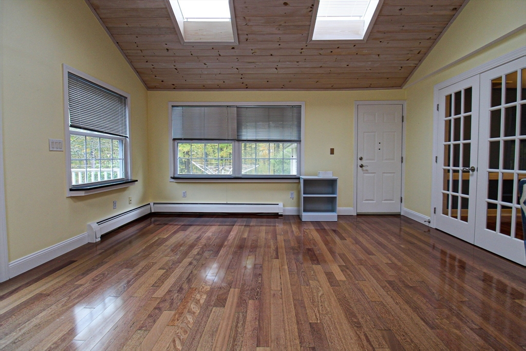 1116 George Hill Road Lancaster, MA 01523 - Photo 12 of 37 wooden floor in an empty room with a window