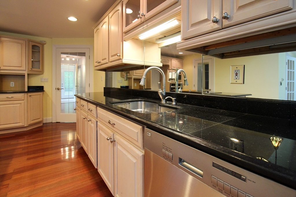 1116 George Hill Road Lancaster, MA 01523 - Photo 16 of 37 a kitchen with granite countertop a sink and cabinets