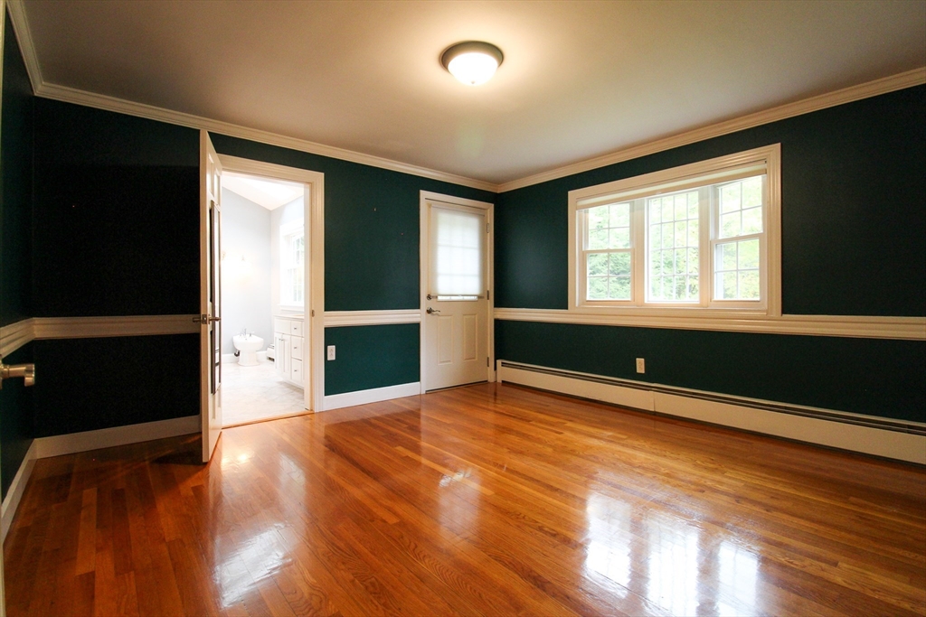 1116 George Hill Road Lancaster, MA 01523 - Photo 18 of 37 an empty room with wooden floor and windows