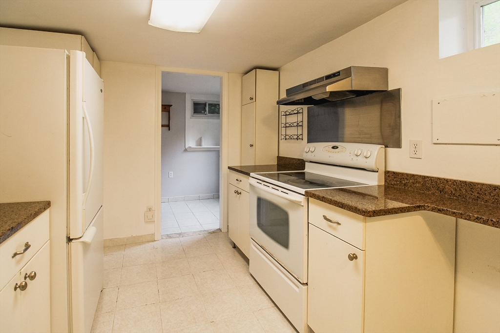 1116 George Hill Road Lancaster, MA 01523 - Photo 30 of 37 a kitchen with granite countertop a sink and a stove top oven
