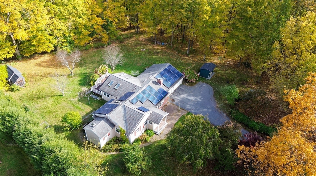 1116 George Hill Road Lancaster, MA 01523 - Photo 3 of 37 an aerial view of a house with garden space and trees all around
