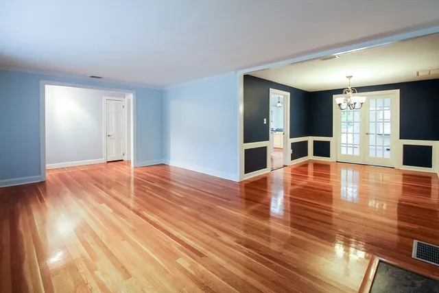 a large room with wooden floor and large window