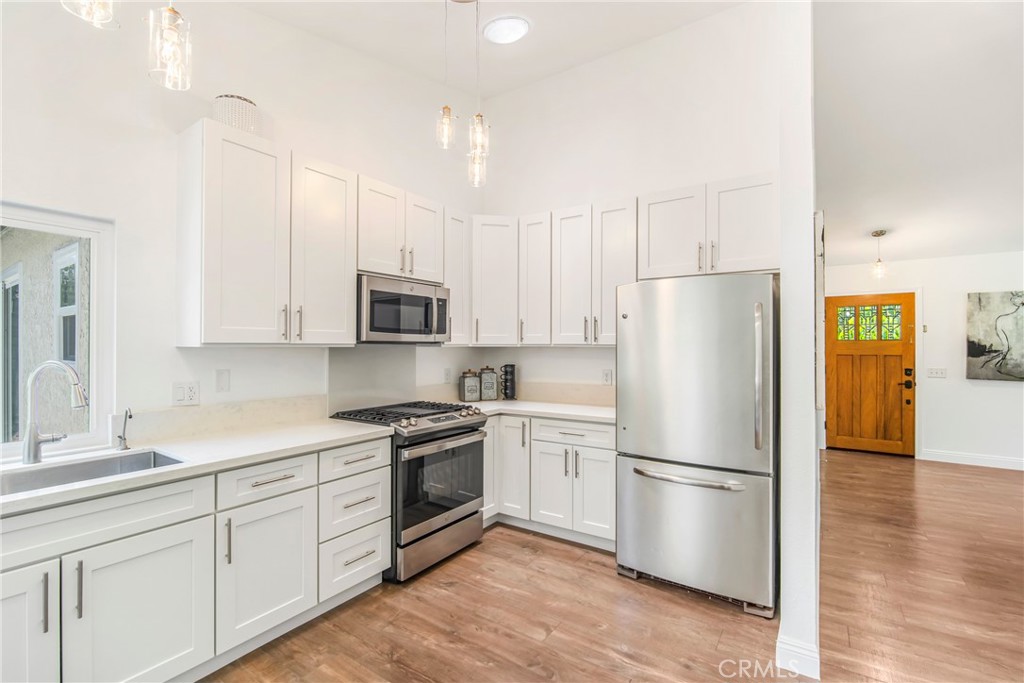 2810 Bello Panorama San Clemente, CA 92673 - Photo 16 of 67 a kitchen with stainless steel appliances granite countertop a refrigerator stove a sink and white cabinets