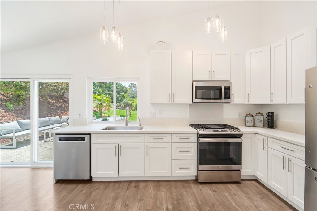 2810 Bello Panorama San Clemente, CA 92673 - Photo 17 of 67 a kitchen with stainless steel appliances white cabinets and a sink