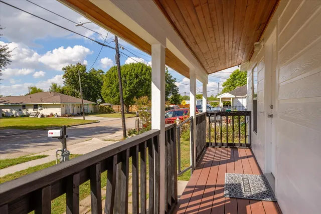 a view of a balcony with wooden floor