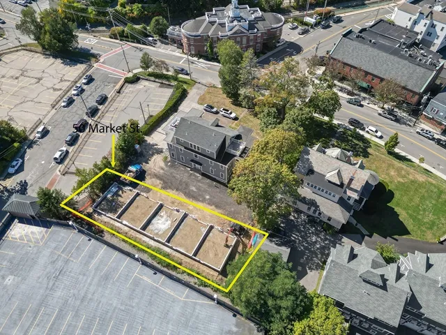 an aerial view of a house with a swimming pool and outdoor seating