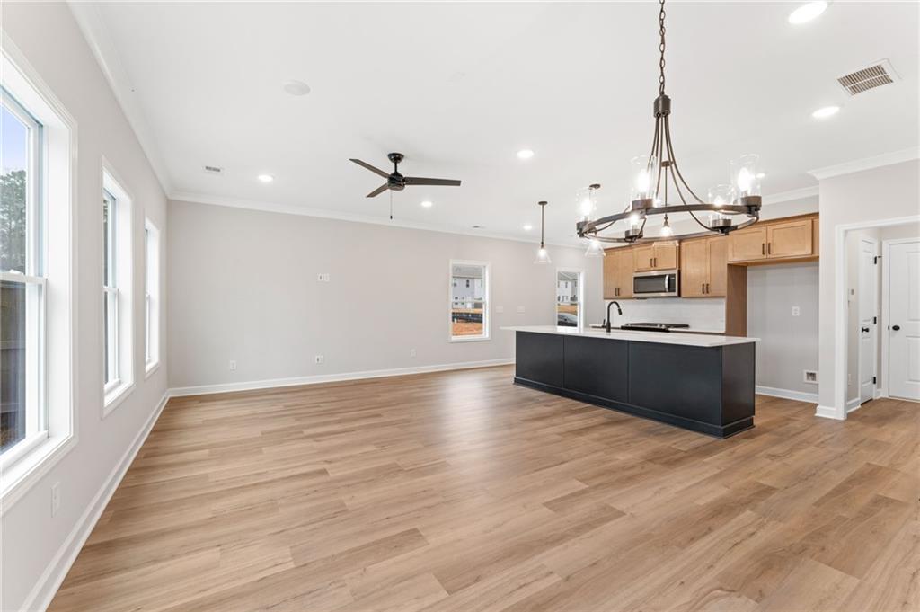 328 Colsen Drive Acworth, GA 30102 - Photo 5 of 23 a view of a kitchen with kitchen island a sink wooden floor and a large window