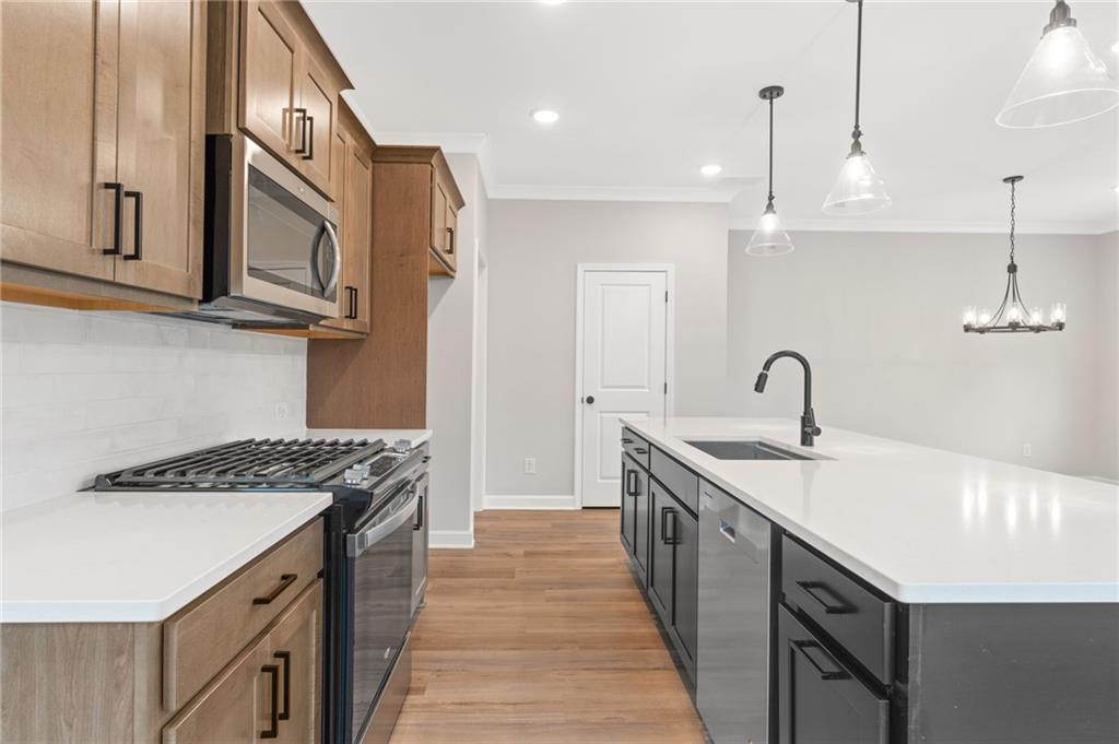 328 Colsen Drive Acworth, GA 30102 - Photo 8 of 23 a kitchen with stainless steel appliances granite countertop a sink a stove and a wooden floors