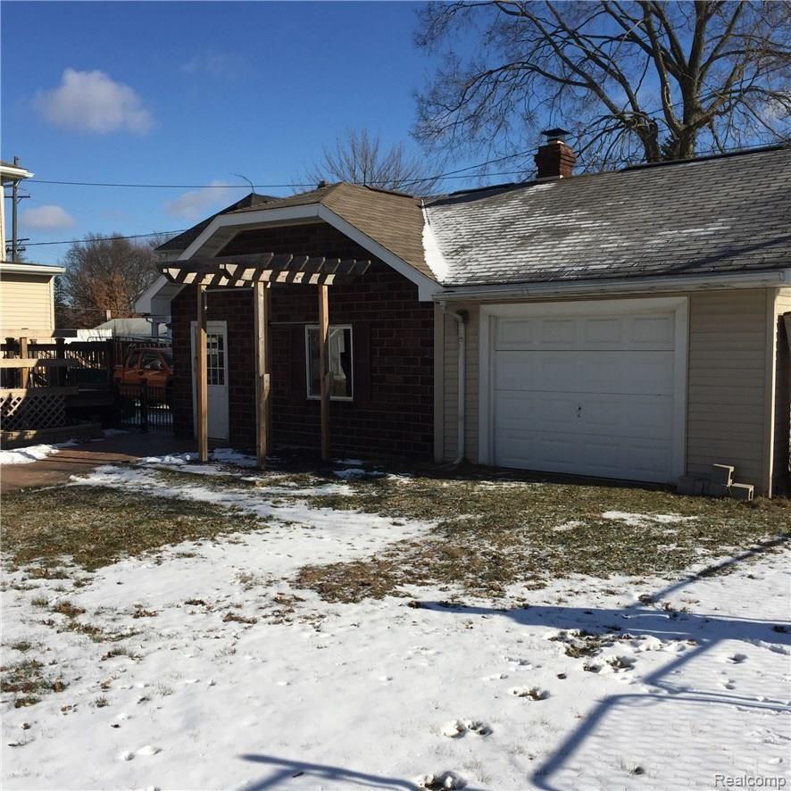 36769 Goddard Road Romulus, MI 48174 - Photo 34 of 34 Workshop behind garage with garage door.