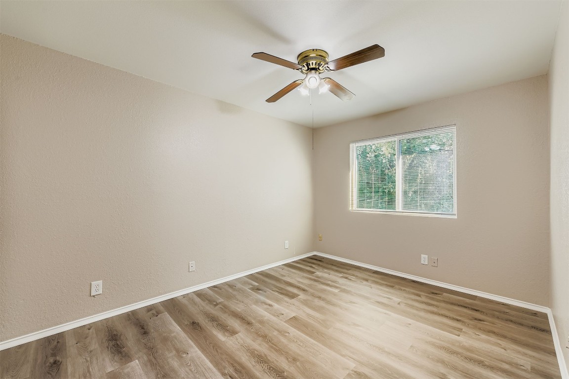 9201 Sedgemoor Trail, Unit A Austin, TX 78748 - Photo 8 of 11 an empty room with a window and a fan