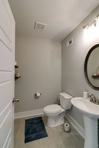 a bathroom with a toilet a sink and a mirror