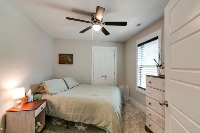 a bedroom with a bed and a window