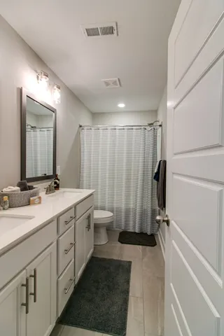 a bathroom with a double vanity sink and mirror