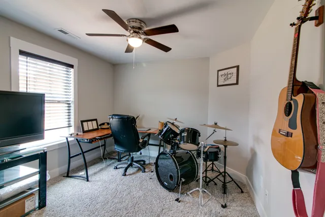 a view of a workspace with furniture and a window