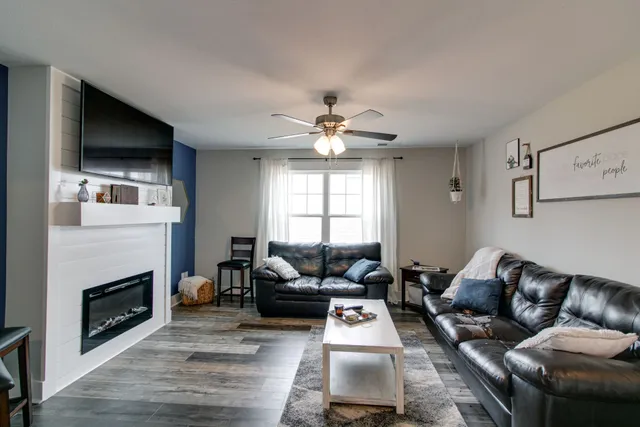 a living room with furniture fireplace and flat screen tv