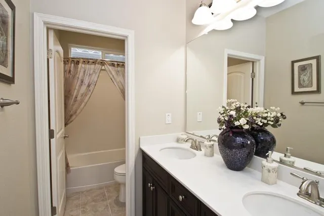 a bathroom with a sink vanity and mirror