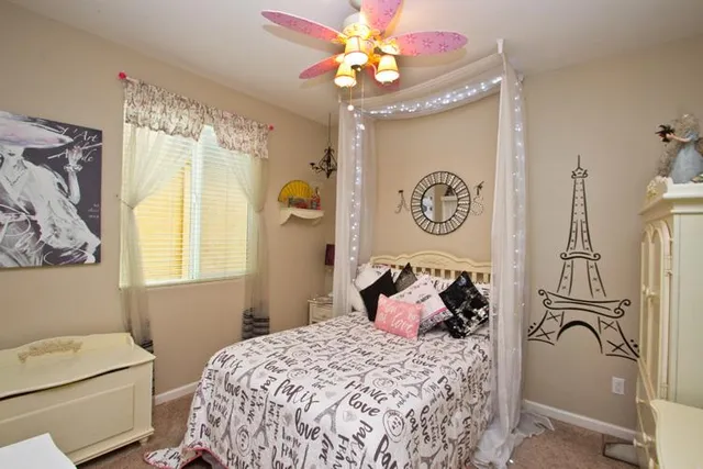 a bedroom with a bed and a chandelier