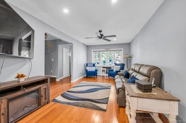 a living room with furniture fireplace and a window