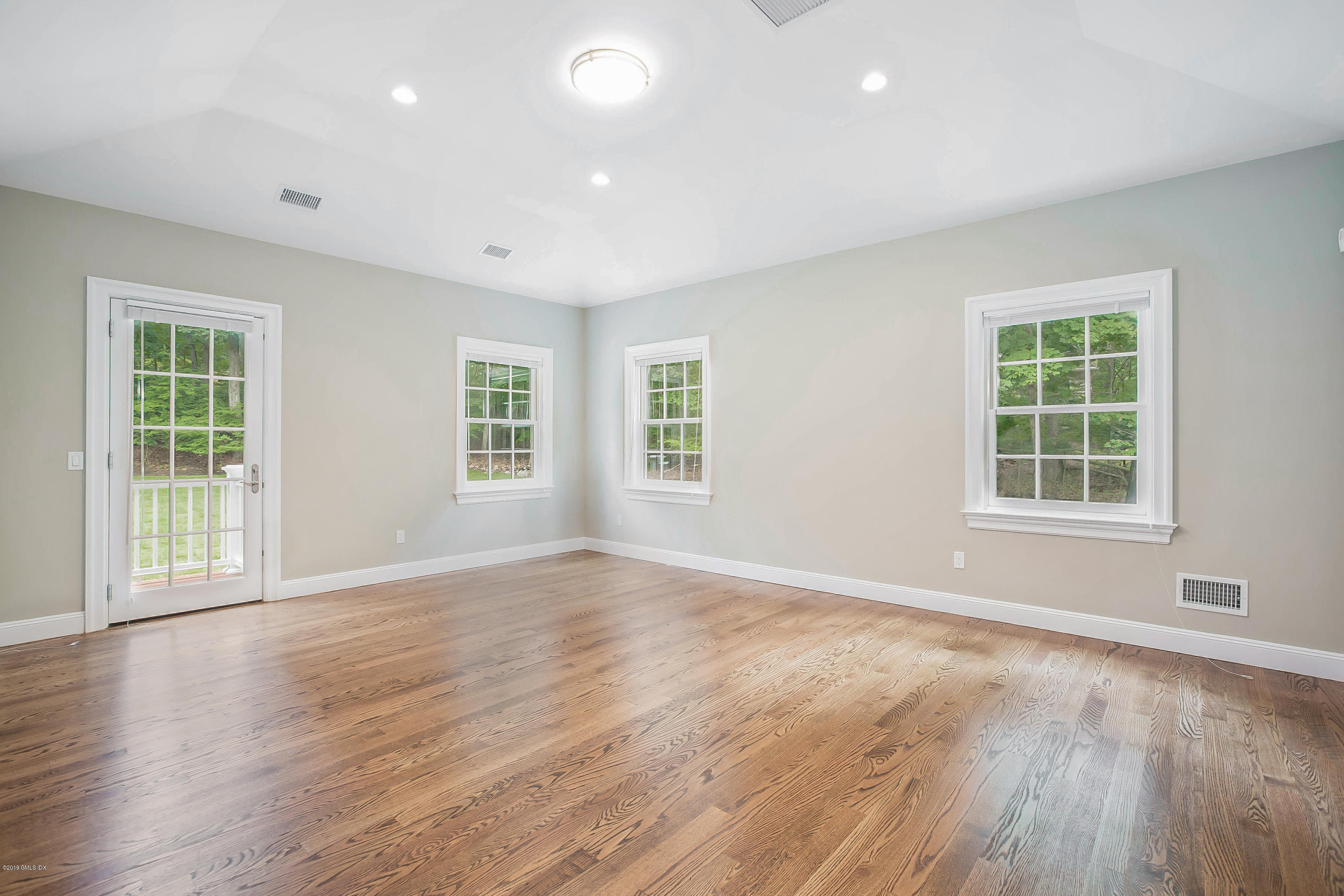 54 Dandy Drive Cos Cob, CT 06807 - Photo 11 of 35 an empty room with wooden floor and windows