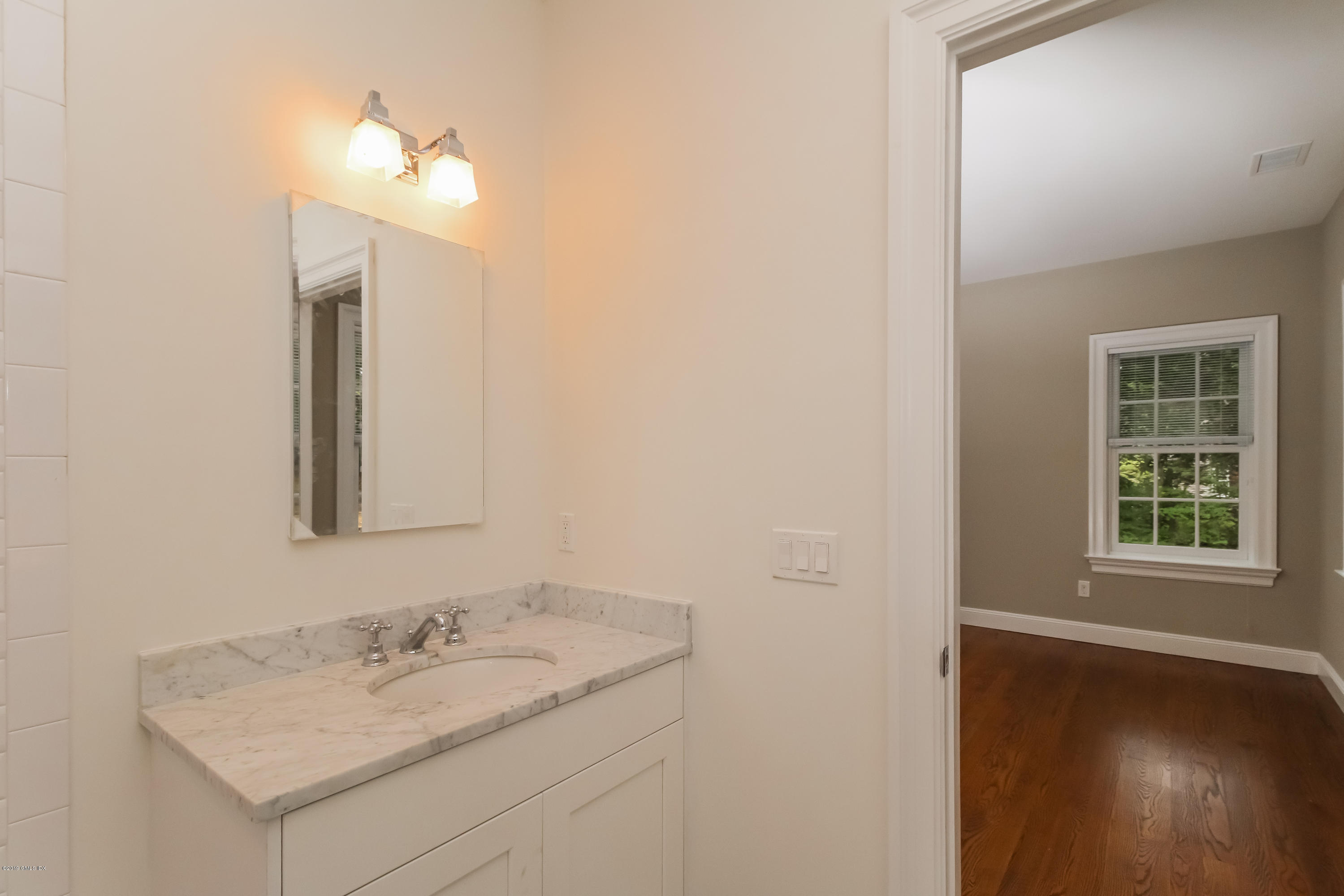 54 Dandy Drive Cos Cob, CT 06807 - Photo 19 of 35 a bathroom with a sink vanity and a mirror
