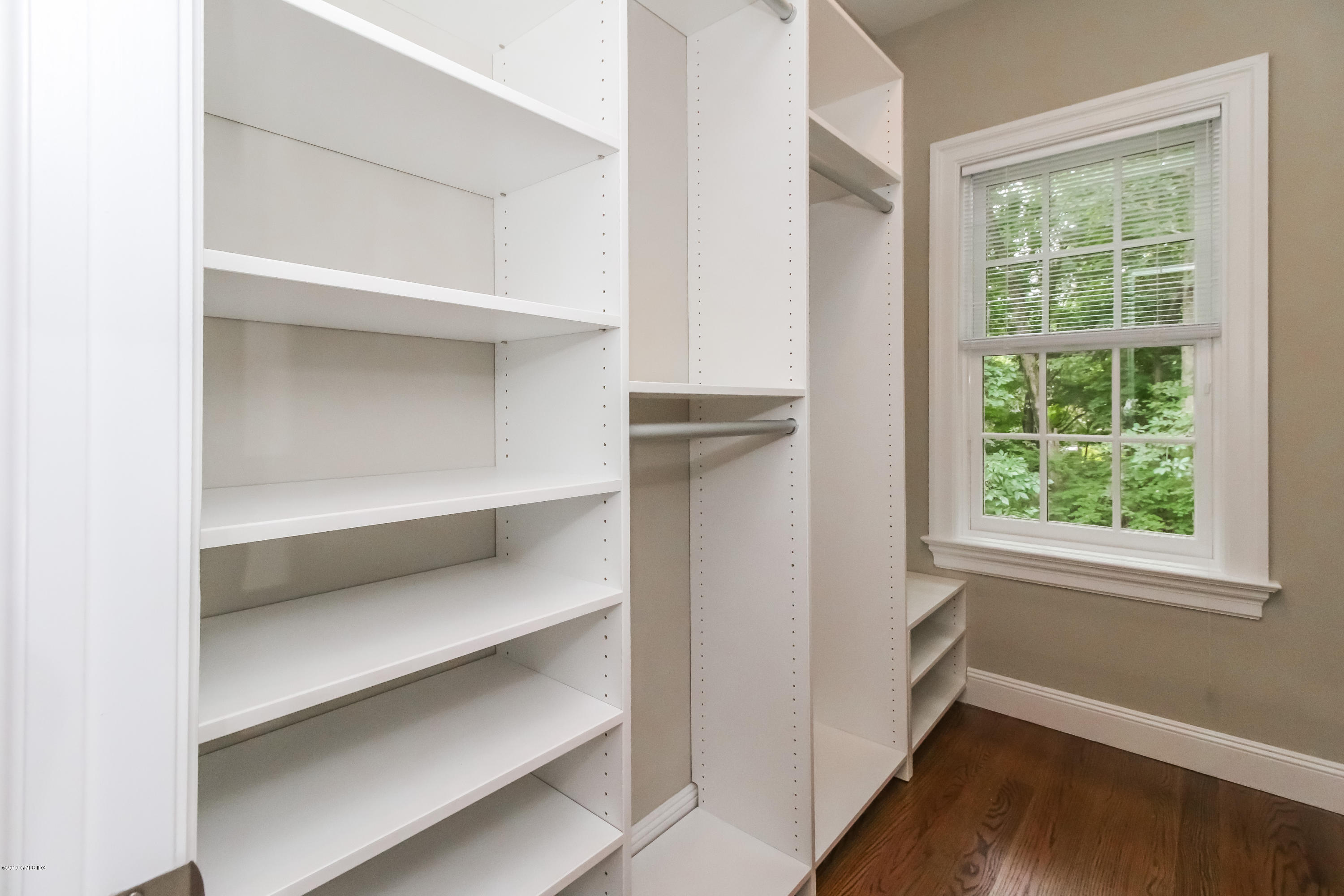 54 Dandy Drive Cos Cob, CT 06807 - Photo 21 of 35 a view of an empty room with wooden floor and window