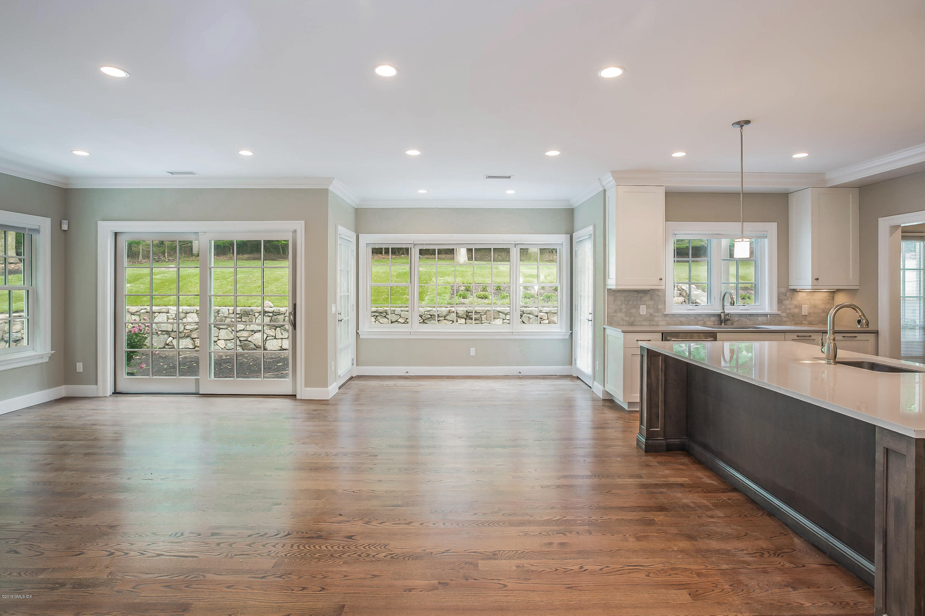 54 Dandy Drive Cos Cob, CT 06807 - Photo 4 of 35 a large kitchen with stainless steel appliances granite countertop a large window and a wooden floors
