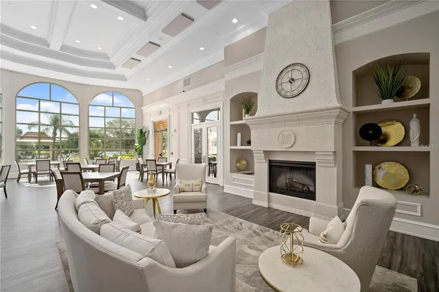 a living room with furniture a clock and a fireplace