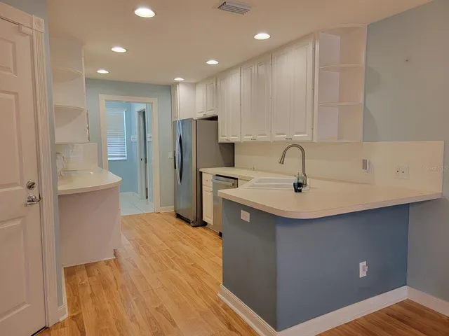 a kitchen with stainless steel appliances a sink and refrigerator