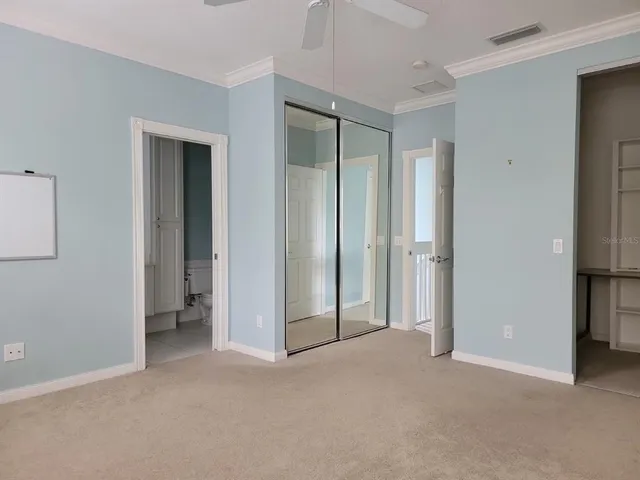 a view of empty room with windows and refrigerator