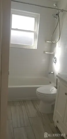 a bathroom with a toilet a sink and a bathtub