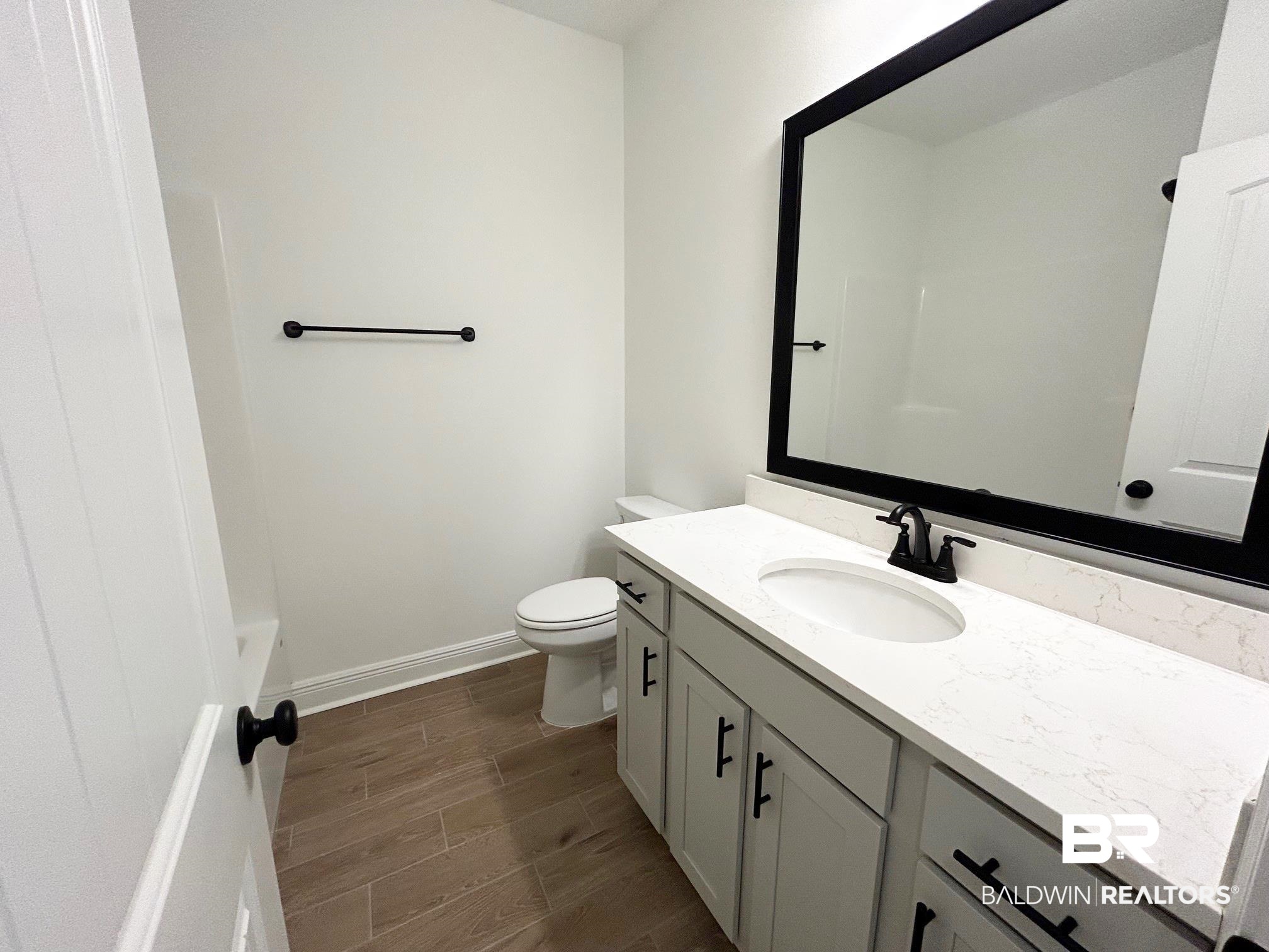 812 Sumter Loop Foley, AL 36535 - Photo 12 of 17 Bathroom with hardwood / wood-style flooring, vanity, and toilet